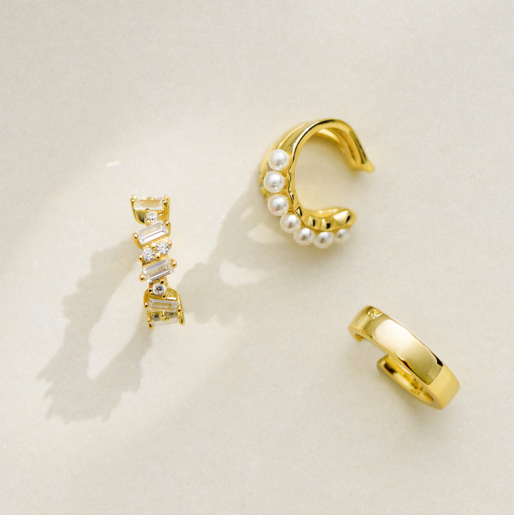 Selection of ear cuffs: Irregular Set Sparkle Ear Cuff Gold Vermeil, Minimalist Gold Vermeil Ear Cuff, Tripe Rows Pearl Ear Cuff Gold Vermeil
